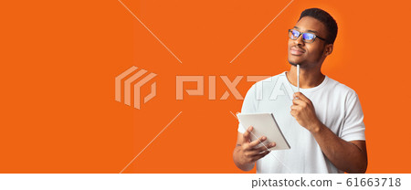 Pensive black guy portrait on orange background Pensive black guy portrait on orange background 61663718