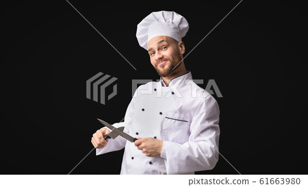 Funny Chef Man Sharpening Knives Standing, Studio Shot, Panorama Funny Chef Man Sharpening Knives Standing, Studio Shot, Panorama 61663980