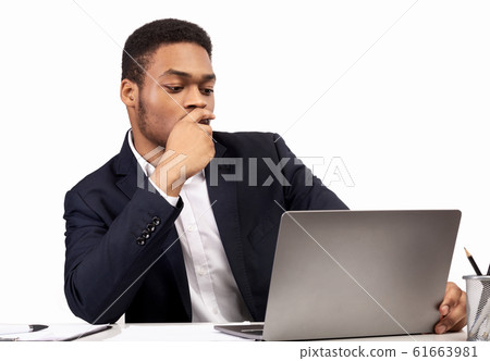 Black guy working on his laptop at office Black guy working on his laptop at office 61663981