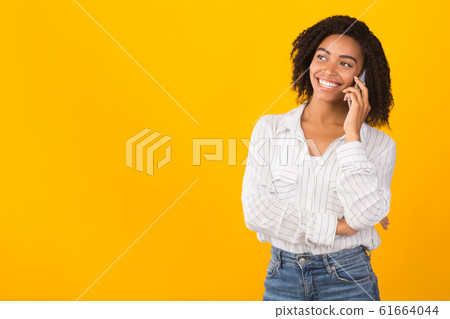 Happy afro model talking on mobile phone Happy afro model talking on mobile phone 61664044