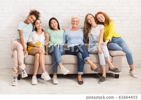 Women Of Different Age Sitting On Sofa Smiling Indoor Women Of Different Age Sitting On Sofa Smiling Indoor 61664455