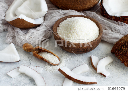 Coconut flour in a wooden bowl with a spoon close Coconut flour in a wooden bowl with a spoon close 61665079
