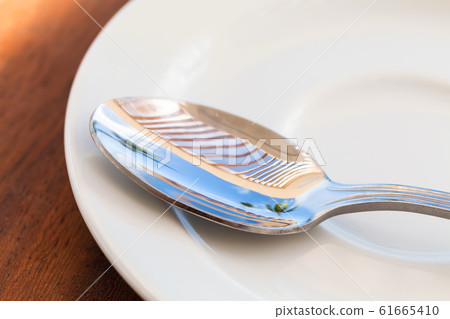 Shiny metal tea spoon with reflections Shiny metal tea spoon with reflections 61665410