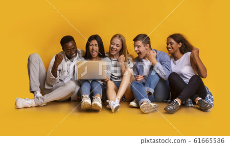 Group of students checking exam results online over yellow background Group of students checking exam results online over yellow background 61665586