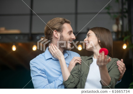 Happy man and a woman kissing each other after engagement Happy man and a woman kissing each other after engagement 61665734