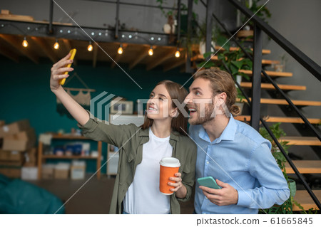 Woman and a man makking a funny selfie 61665845