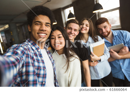 Group selfie of happy international college students 61666064