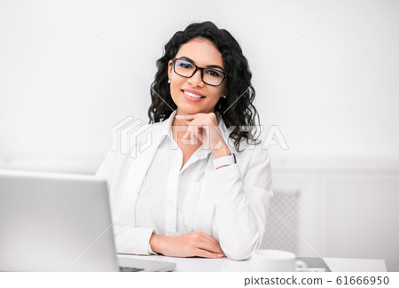 Mexican recruiter looking at camera with hand on chin Mexican recruiter looking at camera with hand on chin 61666950