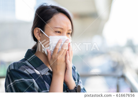 Woman wearing face mask protect filter against air Woman wearing face mask protect filter against air 61667656