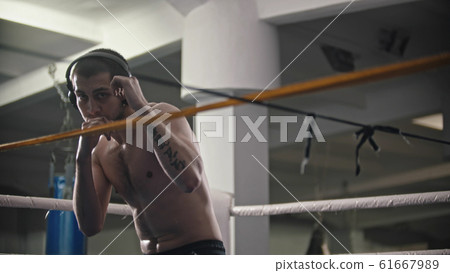 A man boxer training his hits on the ring A man boxer training his hits on the ring 61667989