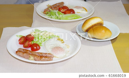 Meal of sausage and fried egg and salad Meal of sausage and fried egg and salad 61668019