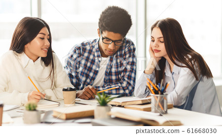 High school students studying and reading together in library High school students studying and reading together in library 61668030
