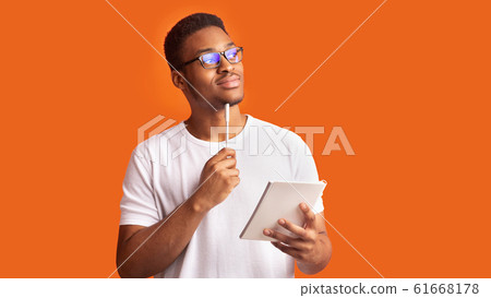 Pensive afro man portrait on orange background Pensive afro man portrait on orange background 61668178