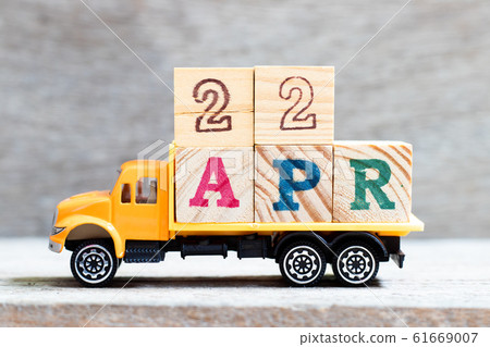 Truck hold letter block in word 22apr on wood background  61669007