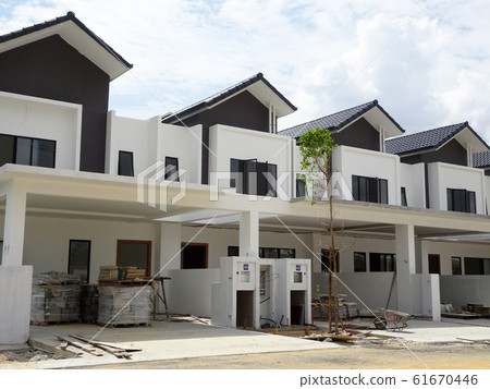 New double story luxury terrace house under construction in Malaysia. Designed by an architect with a modern and contemporary style. New double story luxury terrace house under construction in Malaysia. Designed by an architect with a modern and contemporary style. 61670446