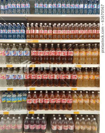 Soft drinks or carbonated drinks arranged and stacked on the rack inside the huge supermarket for sale. Sorted by the brand to make easy for the customer to buy Soft drinks or carbonated drinks arranged and stacked on the rack inside the huge supermarket for sale. Sorted by the brand to make easy for the customer to buy 61670567