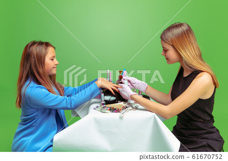 Little girl dreaming about future profession of nails manicure artist Little girl dreaming about future profession of nails manicure artist 61670752