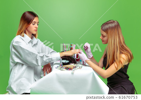 Little girl dreaming about future profession of nails manicure artist Little girl dreaming about future profession of nails manicure artist 61670753