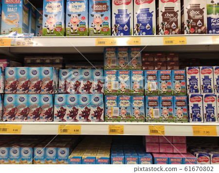 Processed and fresh milk packed in the paper box and displayed on the rack inside the supermarkets. Sorted by brand and type for easy for the customer to choose. Processed and fresh milk packed in the paper box and displayed on the rack inside the supermarkets. Sorted by brand and type for easy for the customer to choose. 61670802