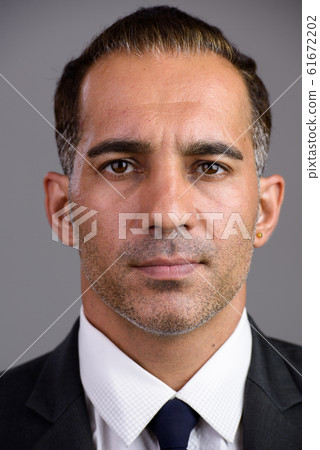 Face of mature handsome Persian businessman in suit Face of mature handsome Persian businessman in suit 61672202