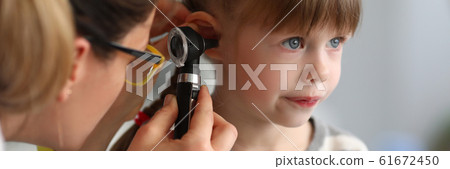 Pediatrician examines ear of sick child in office Pediatrician examines ear of sick child in office 61672450