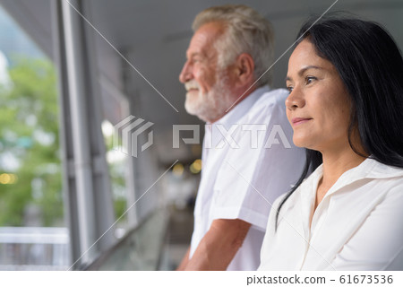 Mature multi-ethnic couple happy and in love while exploring the Mature multi-ethnic couple happy and in love while exploring the 61673536