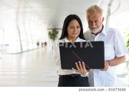 Mature multi-ethnic couple happy and in love while exploring the 61673686