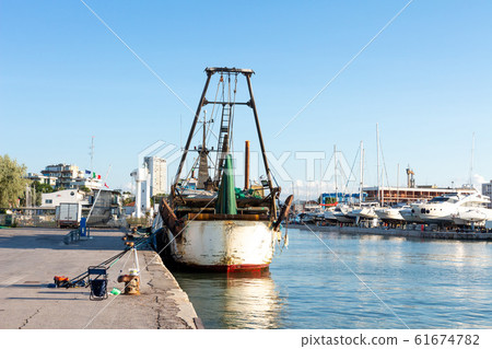 fishing boat moored in small sea harbor fishing boat moored in small sea harbor 61674782