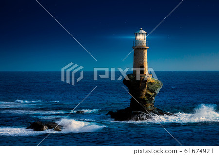 The beautiful Lighthouse Tourlitis of Chora at night. Andros island, Cyclades, Greece 61674921
