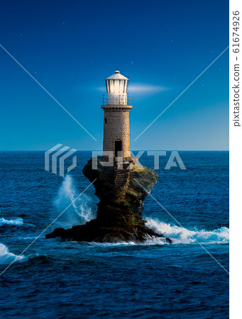 The beautiful Lighthouse Tourlitis of Chora at night. Andros island, Cyclades, Greece 61674926