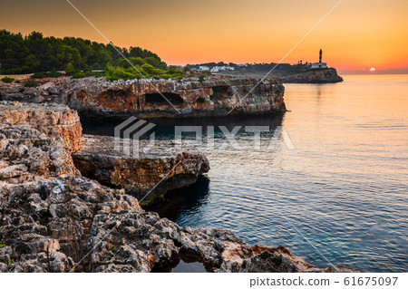 Sunrise with rocks and Porto colom lighthouse Sunrise with rocks and Porto colom lighthouse 61675097