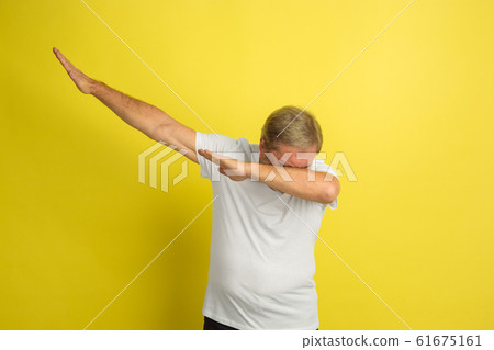 Caucasian senior man's portrait isolated on yellow studio background 61675161