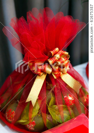 Tangerine Fruits in tray in Chinese Wedding Ceremony Tangerine Fruits in tray in Chinese Wedding Ceremony 61675387