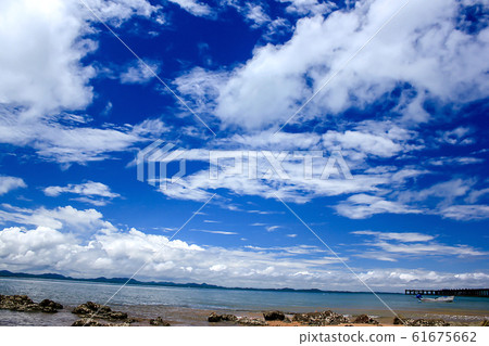 Mountains in the sea and clouds on the blue sky 61675662