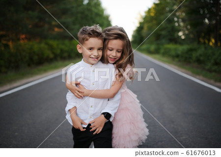 young happy boy and girl together outside young happy boy and girl together outside 61676013