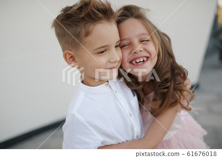 young happy boy and girl together outside young happy boy and girl together outside 61676018