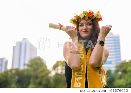 Young beautiful woman celebrating graduation at the park in Bang 61676020
