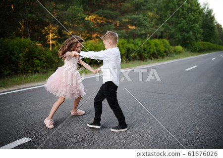 young happy boy and girl together outside young happy boy and girl together outside 61676026