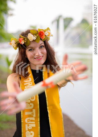 Young beautiful woman celebrating graduation at the park in Bang Young beautiful woman celebrating graduation at the park in Bang 61676027
