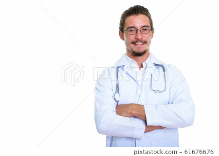 Studio shot of young happy man doctor smiling with arms crossed 61676676