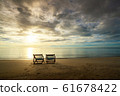 Two Beach Chairs standing in beach with beautiful 61678422