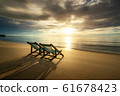 Two Beach Chairs standing in beach with beautiful 61678423