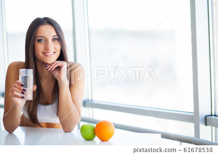 Beautiful Smiling Woman Taking Vitamin Pill. Dietary Supplement 61678538