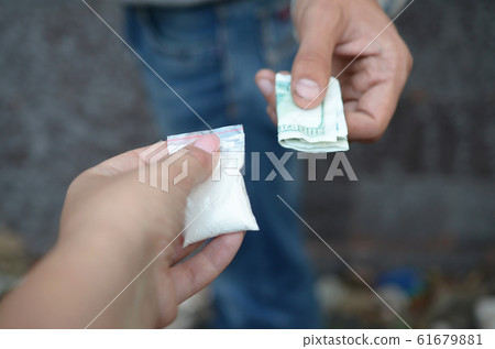 Hand of addict man with money buying dose of Hand of addict man with money buying dose of 61679881