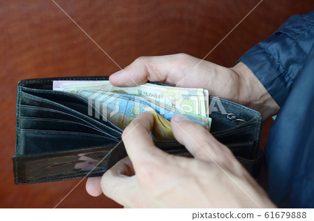 Close up male hands opened the wallet or purse 61679888