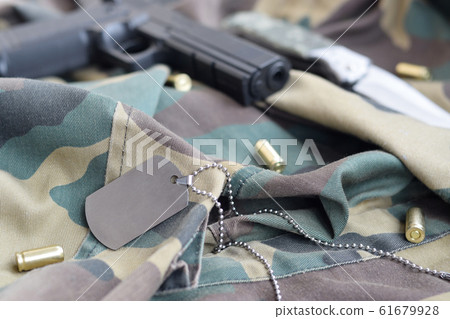 Army Dog tag token with 9mm bullets and pistol lie Army Dog tag token with 9mm bullets and pistol lie 61679928