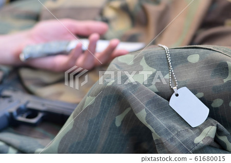 Empty army token of dead military soldier lies on Empty army token of dead military soldier lies on 61680015