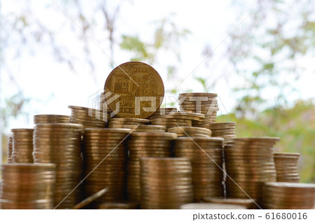 Big amount of bitcoin stacks on blurred green Big amount of bitcoin stacks on blurred green 61680016