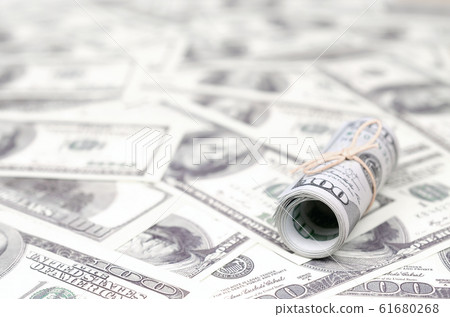 US dollars rolled up and tightened with band lies US dollars rolled up and tightened with band lies 61680268