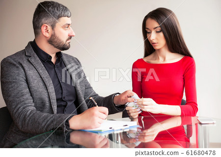 Business. Business Woman Gives Money to Men. Woman Dressed in Re Business. Business Woman Gives Money to Men. Woman Dressed in Re 61680478